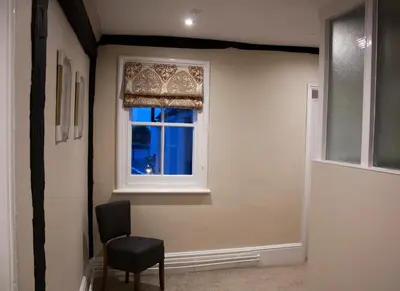 a room with a window and a chair and a windowvisor at The Swan Hotel Bar and Grill in Maldon