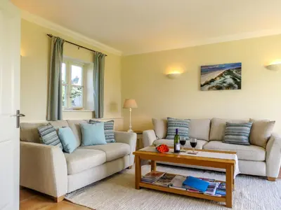 a living room with two couches and a coffee table at Sanderling Home in Aldeburgh