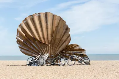 two bikes parked under a large shell on the beach at Sanderling Home in Aldeburgh