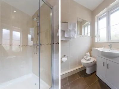 a bathroom with a shower and a sink and a toilet at 1 Suffolk Cottage, Knodishall - Aldeburgh Coastal Cottages in Aldeburgh