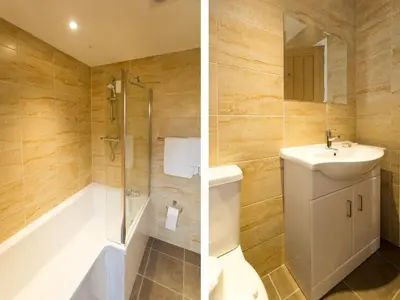 a bathroom with a sink and a shower and a toilet at 1 Suffolk Cottage, Knodishall - Aldeburgh Coastal Cottages in Aldeburgh