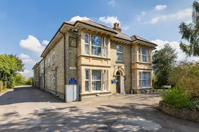 an old brick building with a lot of windows at Shelford Lodge in Cambridge