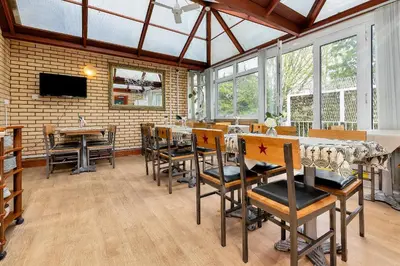 a dining room with a table and some chairs at Shelford Lodge in Cambridge