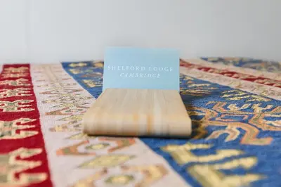 a blue sign sitting on top of a rug at Shelford Lodge in Cambridge