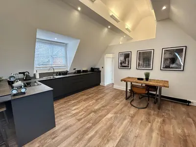 a large kitchen with a table and a counter at Booking Urban at Stisted in Braintree