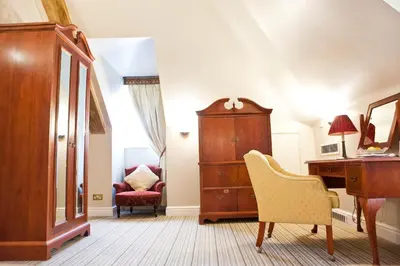 a room with a dresser and a desk and a chair at Marygreen Manor in Brentwood