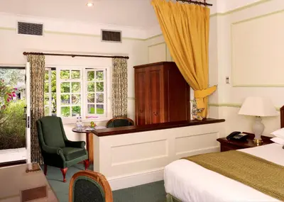 a hotel room with a desk and a bed at Marygreen Manor in Brentwood