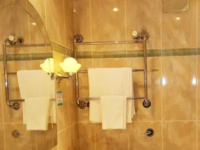 a bathroom with white towels hanging on a shower at Marygreen Manor in Brentwood
