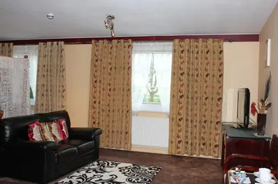 a living room with a couch and a window at Desalis Hotel London Stansted in Elsenham