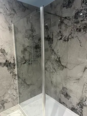 a shower with a glass door in a bathroom at Desalis Hotel London Stansted in Elsenham