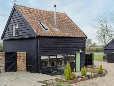 a black house with a black roof at The Dairy - Ukc1546 in Heveningham