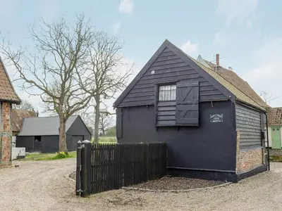 a black house with a window on the side of it at The Dairy - Ukc1546 in Heveningham