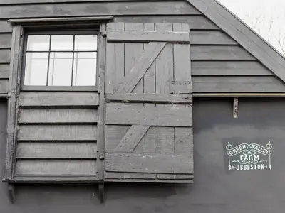a wooden door on the side of a building at The Dairy - Ukc1546 in Heveningham