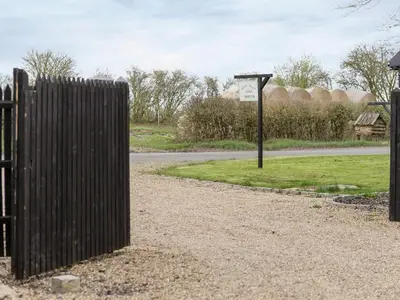 a gate with a sign next to a road at The Dairy - Ukc1546 in Heveningham