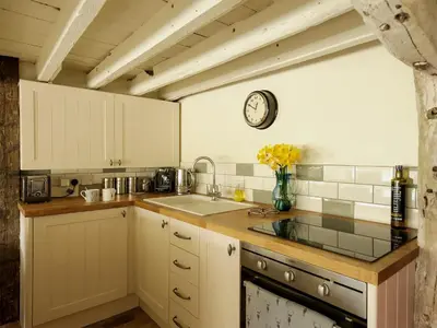 a kitchen with a sink and a clock on the wall at The Dairy - Ukc1546 in Heveningham