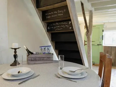 a table with plates and utensils on top of it at The Dairy - Ukc1546 in Heveningham