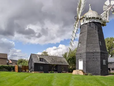 a large windmill in front of a house at Millers Rest in Willingham