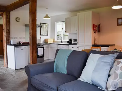 a living room with a couch and a kitchen at Millers Rest in Willingham