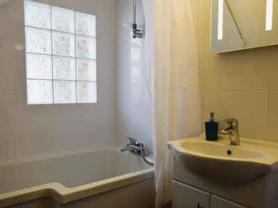 a bathroom with a sink and a tub and a shower curtain at Millers Rest in Willingham