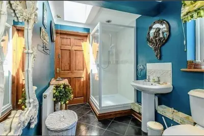 a bathroom with a shower and a sink and a toilet at Little Croft in Haddenham