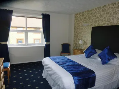 a hotel room with a bed and a window at The Oakland Hotel in Woodham Ferrers