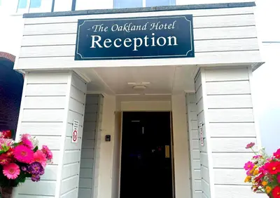 a building with a sign that reads the oxford school reception at The Oakland Hotel in Woodham Ferrers
