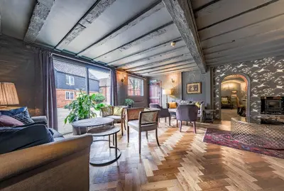 a living room with a couch and a table at The Westleton Crown in Westleton
