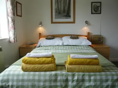 a bedroom with a large bed with two pillows on it at The Kings' House in Bramfield