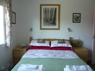 a bedroom with a bed with two towels on it at The Kings' House in Bramfield