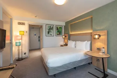 a hotel room with a large bed and a television at Holiday Inn Brentwood by IHG in Brentwood