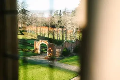 a view through a window of a stone bridge at Fanhams Hall, Exclusive Collection in Ware