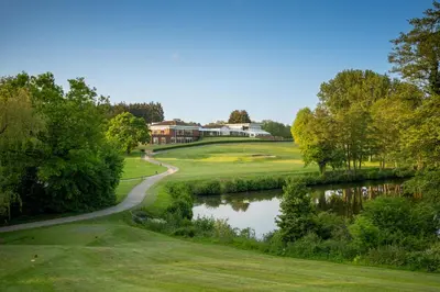 a view of a golf course with a pond at Stoke By Nayland Hotel, Golf & Spa in Leavenheath