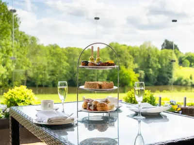a table with a plate of pastries and glasses of wine at Stoke By Nayland Hotel, Golf & Spa in Leavenheath