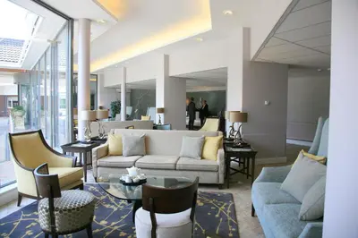 a living room with couches and chairs and tables at Stoke By Nayland Hotel, Golf & Spa in Leavenheath