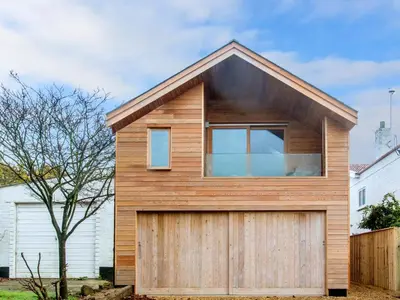 a house with a wooden garage at Laurel Studio in Aldeburgh