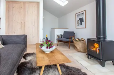 a living room with a fireplace and a couch at Laurel Studio in Aldeburgh