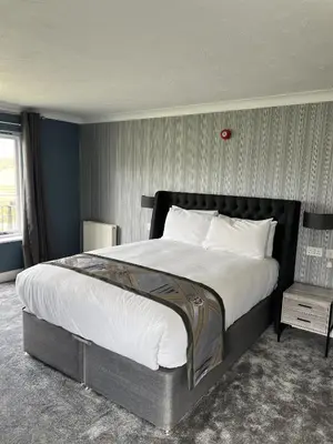 a bedroom with a large bed and a table at Dolphin Hotel St Ives in St Ives
