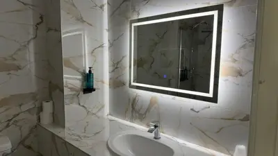 a bathroom with a sink and a mirror at Dolphin Hotel St Ives in St Ives