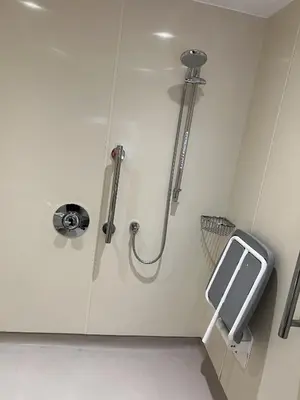 a bathroom with a shower with a soap dispenser at Dolphin Hotel St Ives in St Ives