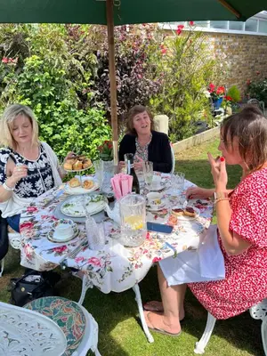 a group of women sitting around a table eating food at Southend Airport Bed & Breakfast in Rochford