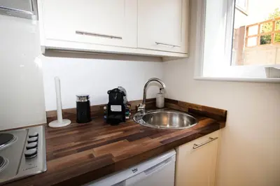 a kitchen counter with a sink and a window at The Grapevine Studio in Cambridge