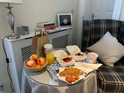 a table with a tray of food and fruit on it at The Grapevine Studio in Cambridge
