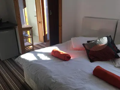a bed with two pillows on top of it at Woodland Lodge in Hoddesdon