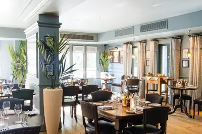 a restaurant with tables and chairs in a room at Hotel du Vin & Bistro Cambridge in Cambridge