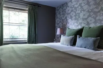 a bedroom with a large bed with a window at Hotel du Vin & Bistro Cambridge in Cambridge