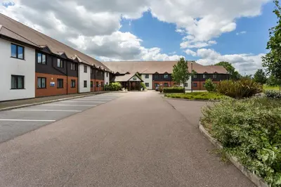 an empty road in front of a building at Holiday Inn Express Colchester by IHG in Colchester