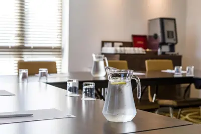 a glass jug of water sitting on a table at Holiday Inn Express Colchester by IHG in Colchester