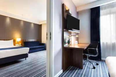 a hotel room with a bed and a desk at Holiday Inn Express Colchester by IHG in Colchester