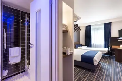 a hotel room with a bed and a bathroom at Holiday Inn Express Colchester by IHG in Colchester