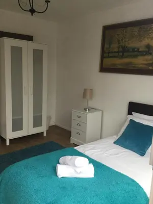 a bedroom with a bed with towels on it at 4 Bed House next to Basildon Town Centre in Basildon